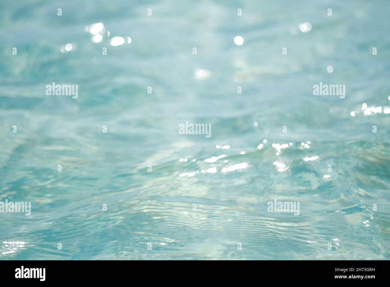 Close-up of blue water in the sea or ocean. Side view. Copy space.Empty showcase,packaging product presentation.Background for cosmetic products. Stock Photo