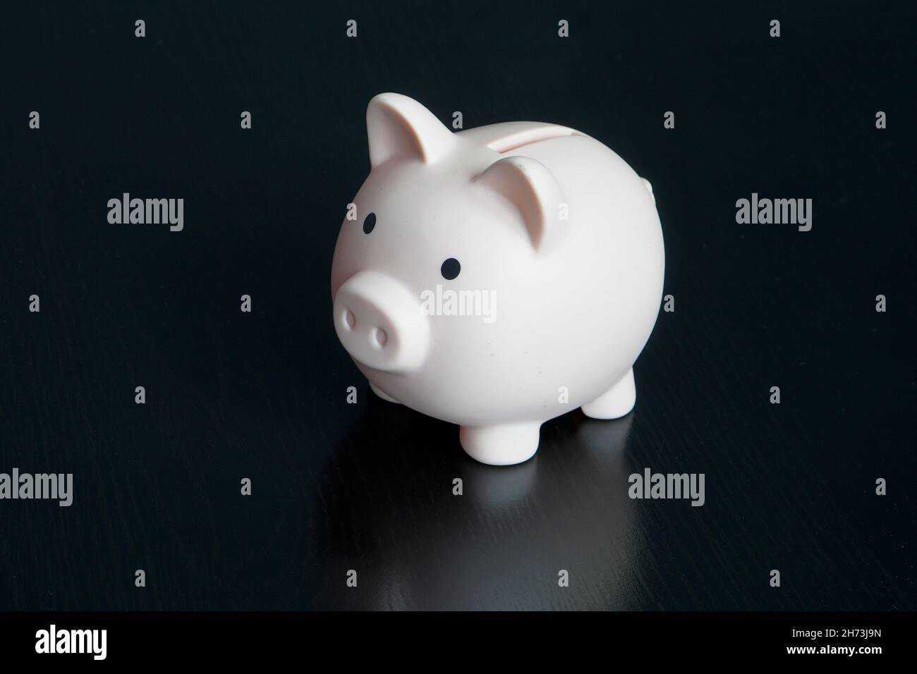 Blue piggy bank money box black studio background Stock Photo - Alamy