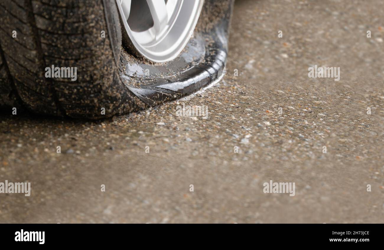 Flat tire car on side of street because expired tyre Stock Photo Alamy