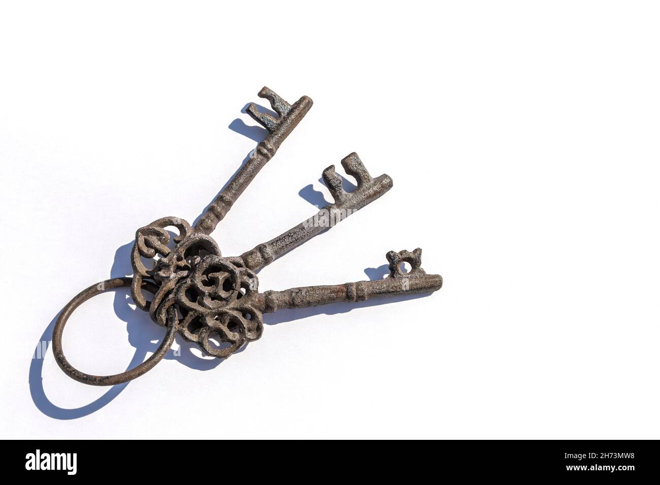 Three old antique metal keys on white background Stock Photo - Alamy