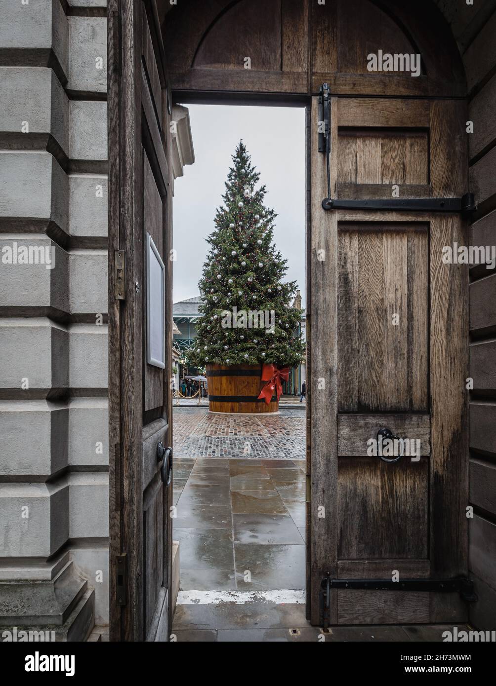 The view of the giant Christmas tree in Covent Garden through the gates