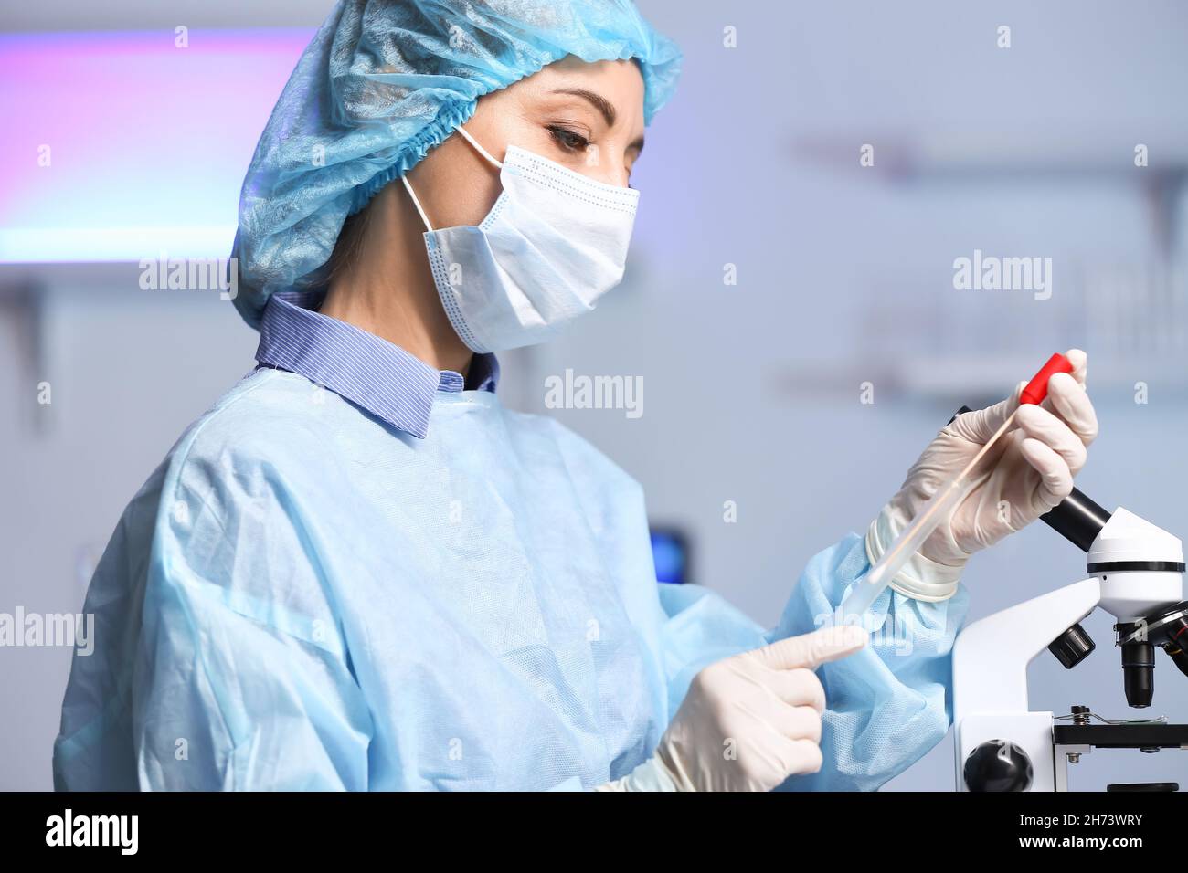 Scientist studying sample in laboratory Stock Photo