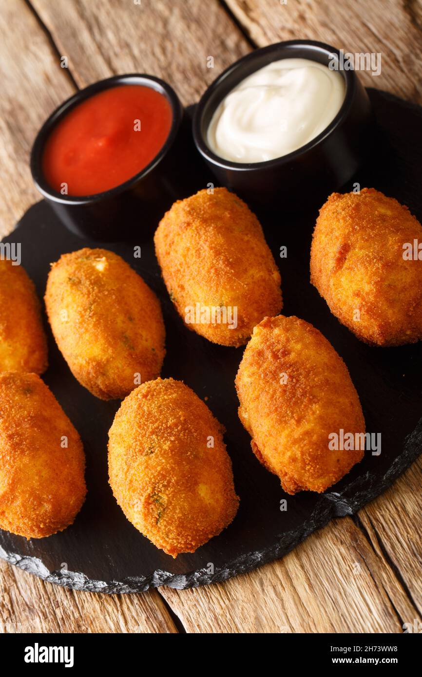Salt cod croquettes croquetas de bacalao with sauces close up in the