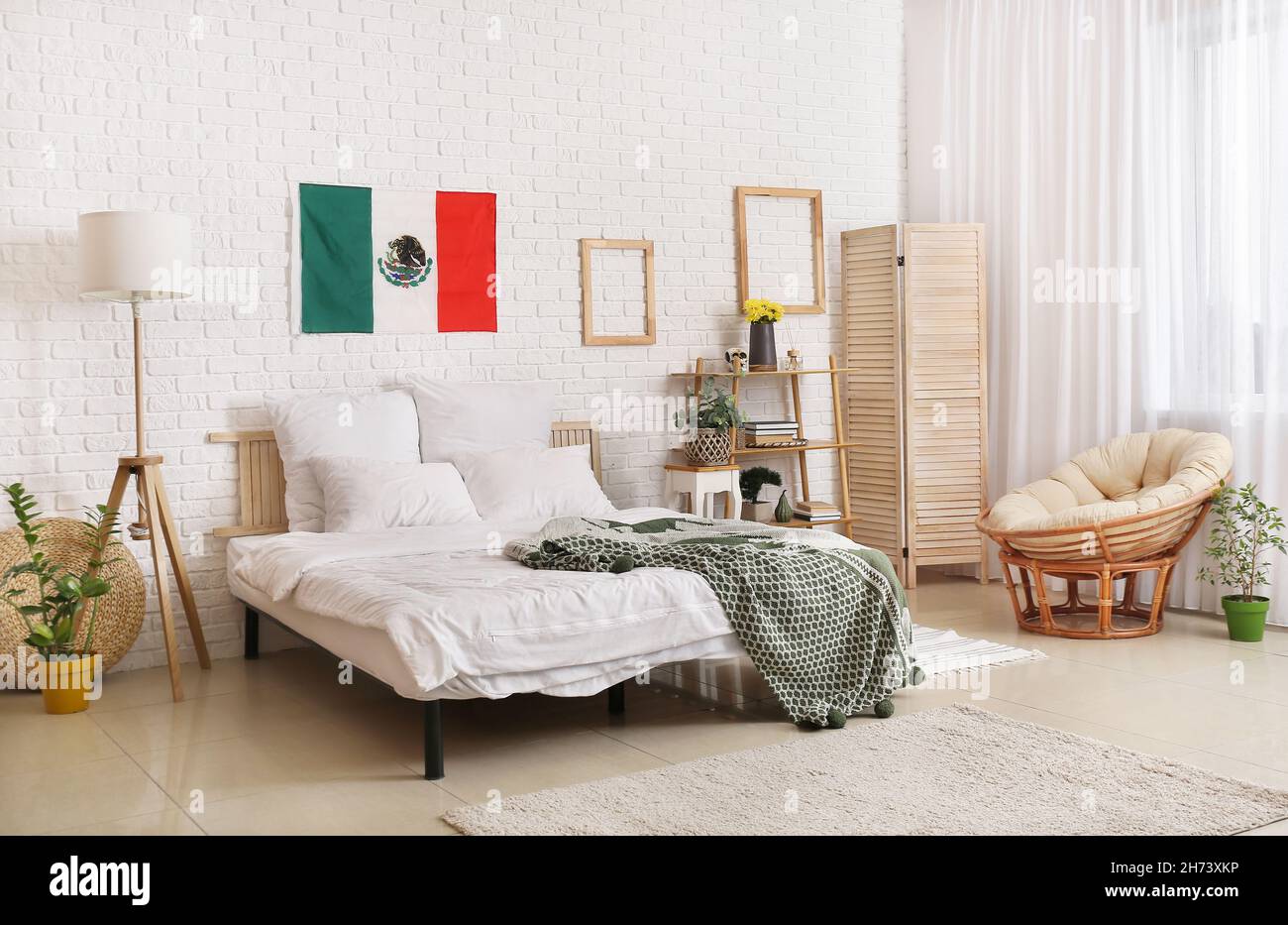 Interior of stylish bedroom with Mexican flag Stock Photo