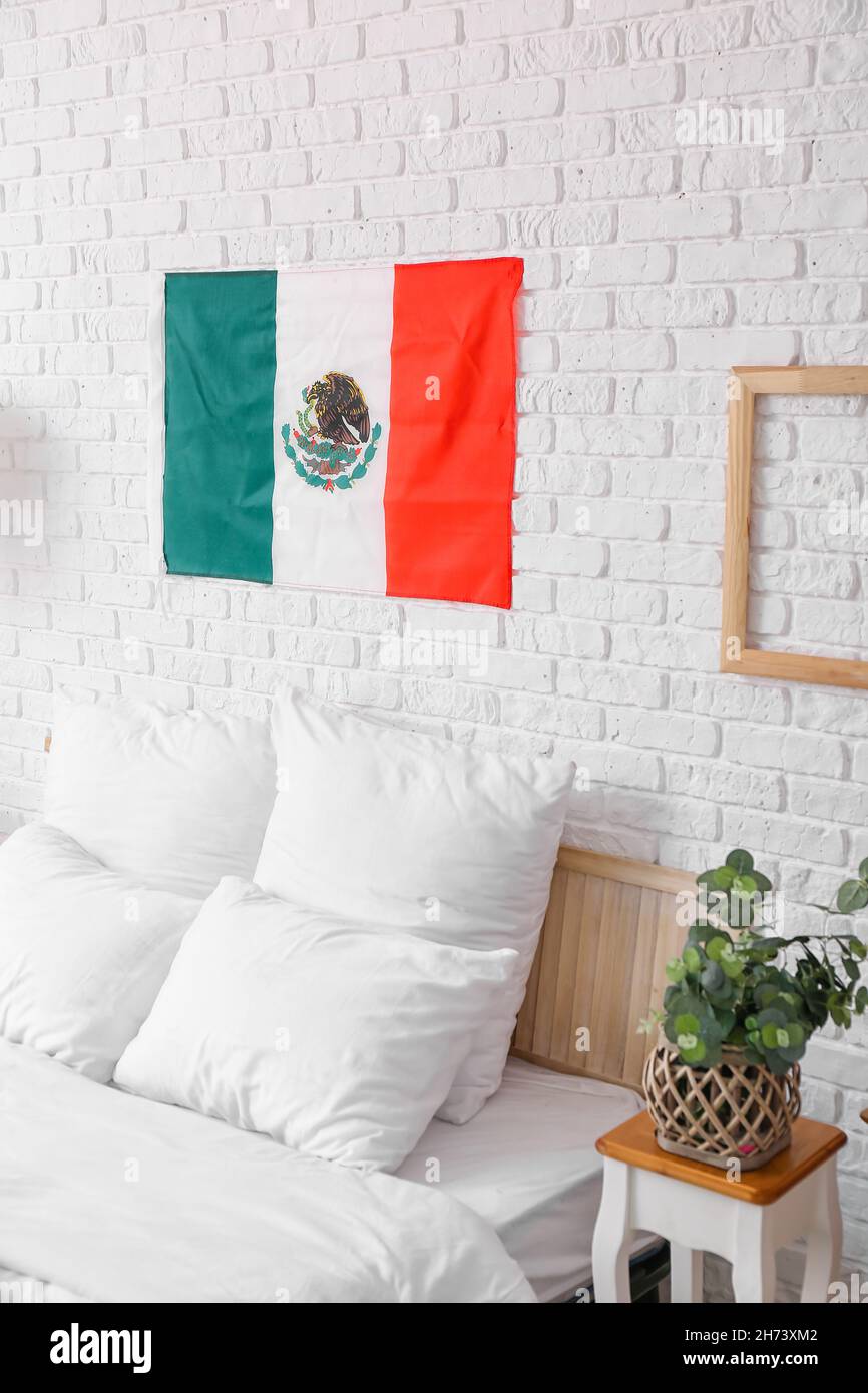 Interior of stylish bedroom with Mexican flag Stock Photo