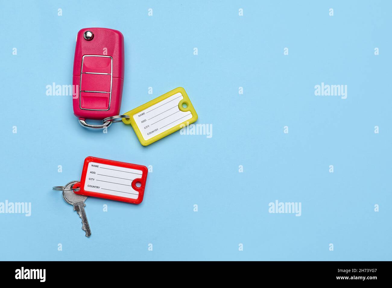 Keys with plastic tags on blue background Stock Photo