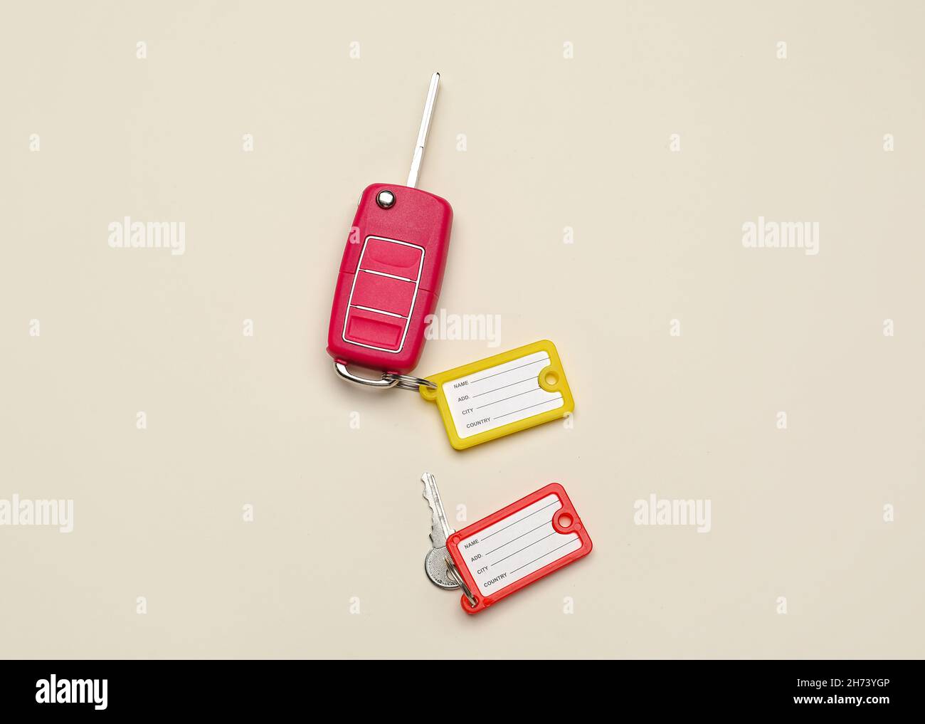 Keys with plastic tags on beige background, top view Stock Photo