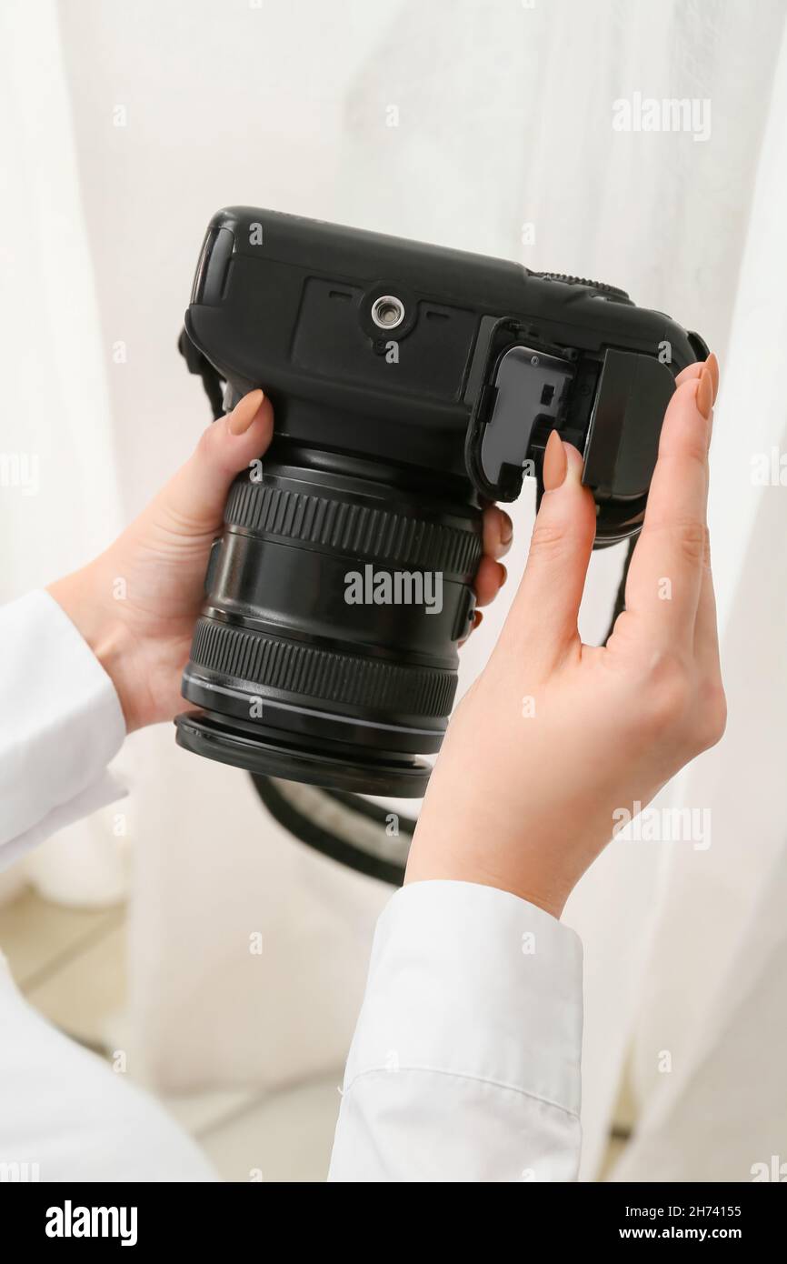 Woman putting battery in camera, closeup Stock Photo Alamy