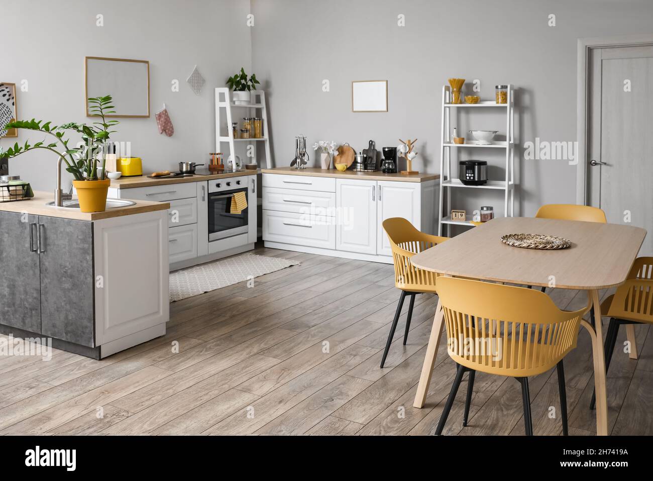 Modern interior of kitchen with dining table Stock Photo - Alamy