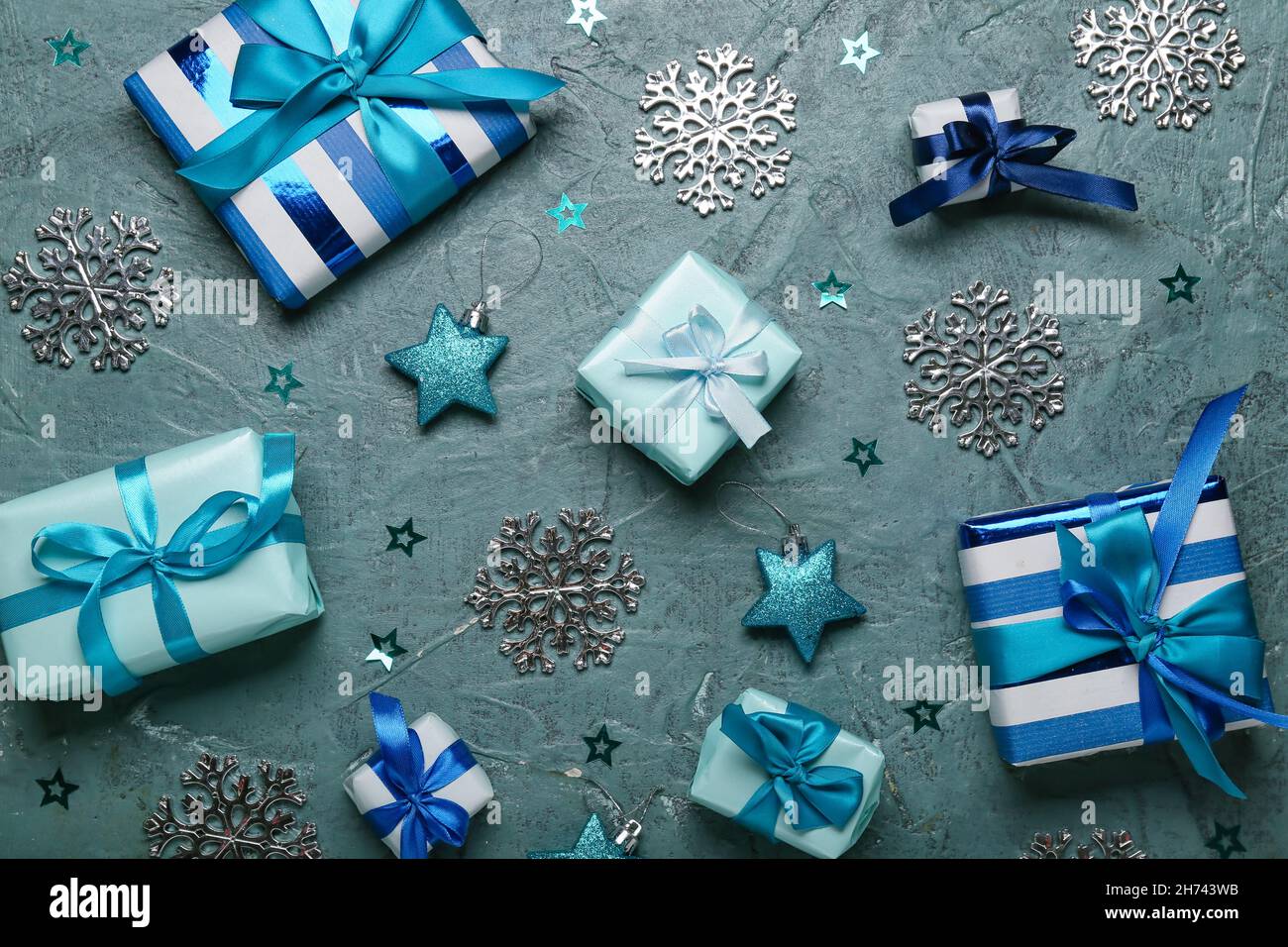 Composition with Christmas gift boxes and decor on black background ...