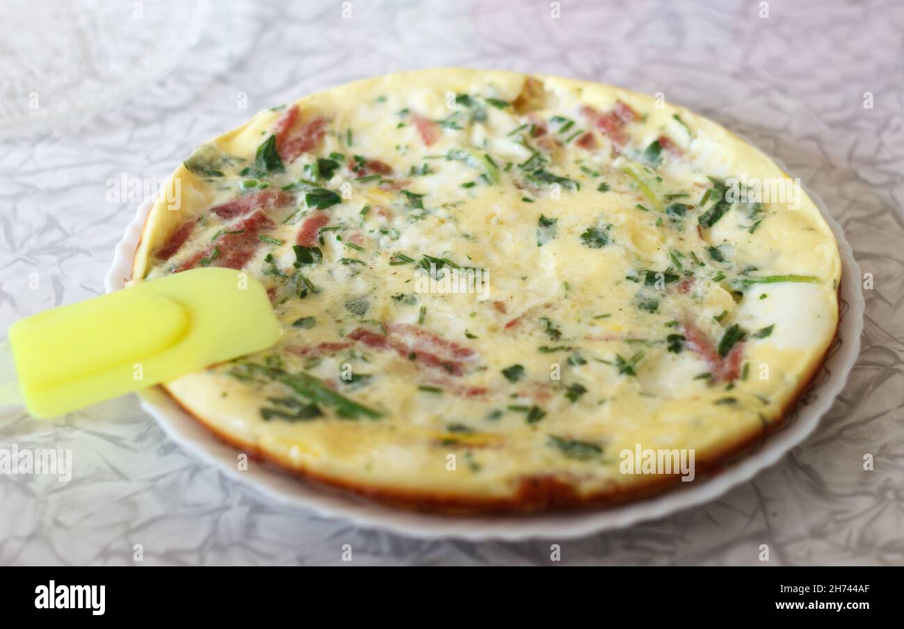 tasty magnificent omelet with greens and sausage for breakfast Stock Photo