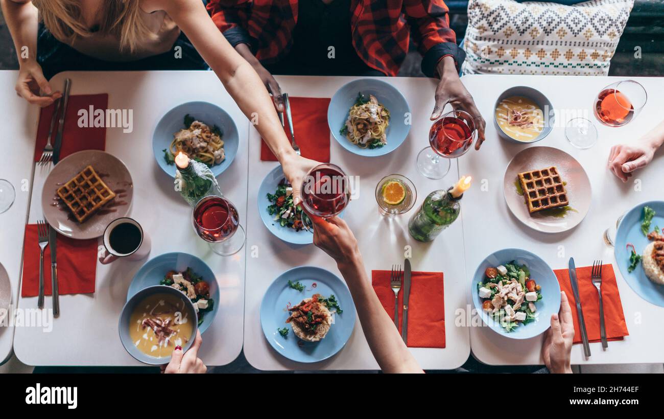 People are sitting at a table and eating. Top view. Stock Photo