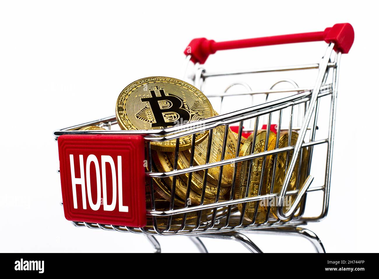 side view closeup cryptocurrency concept of market shopping cart full of  bitcoin golden crypto coins with word hodl written on front isolated on  white Stock Photo - Alamy