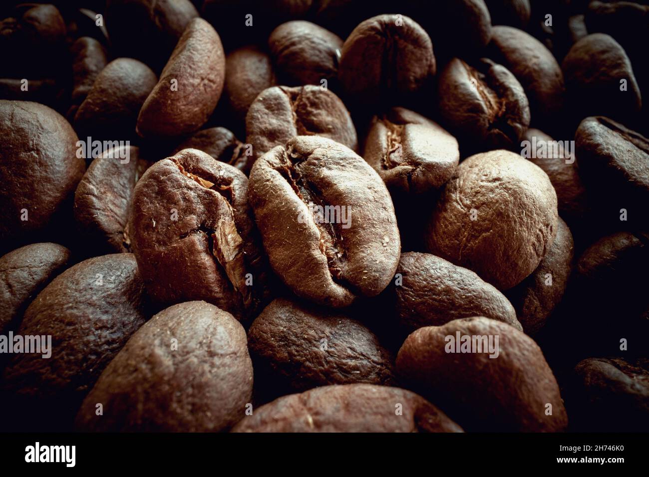 Zoomed in a bunch of fragrant and aromatic roasted coffee beans. Coffee, beverage, producing Stock Photo