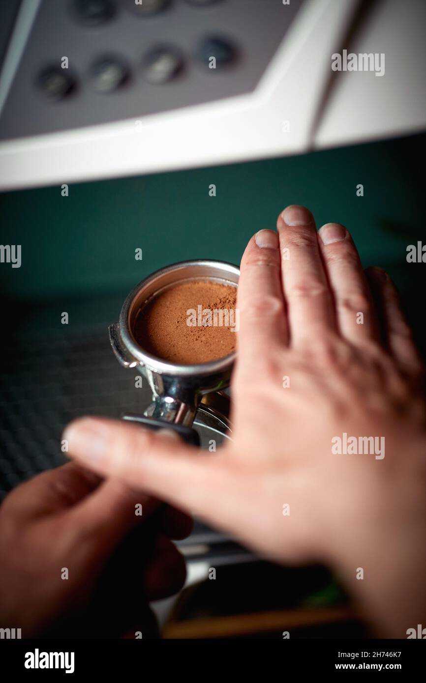 Barman's hands are making an aromatic and fragrant espresso. Coffee, beverage, bar Stock Photo