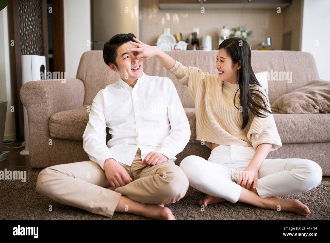 East asian couple sitting on the floor hi-res stock photography and ...