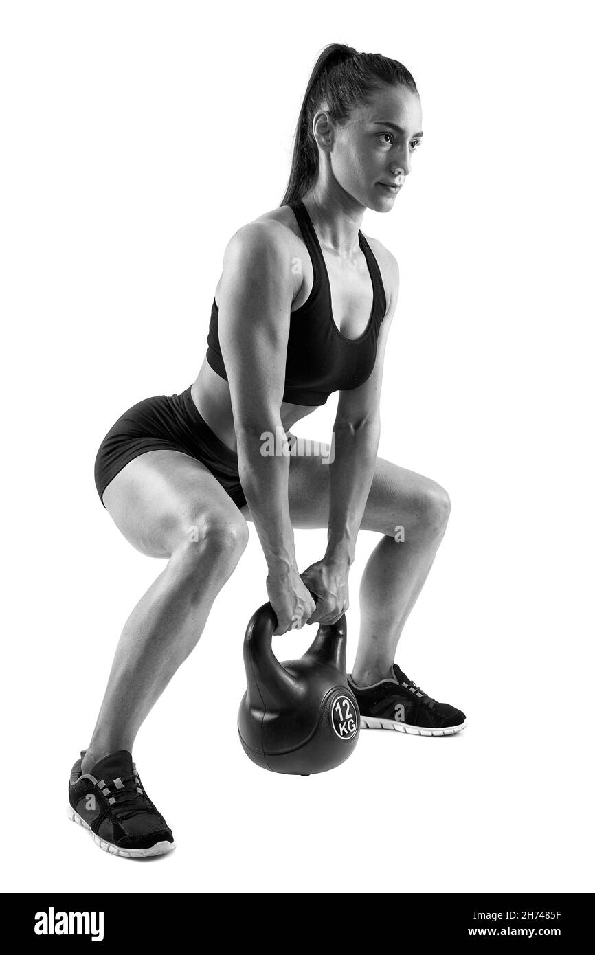 Young athletic woman doing workout with kettlebell isolated on white background Stock Photo