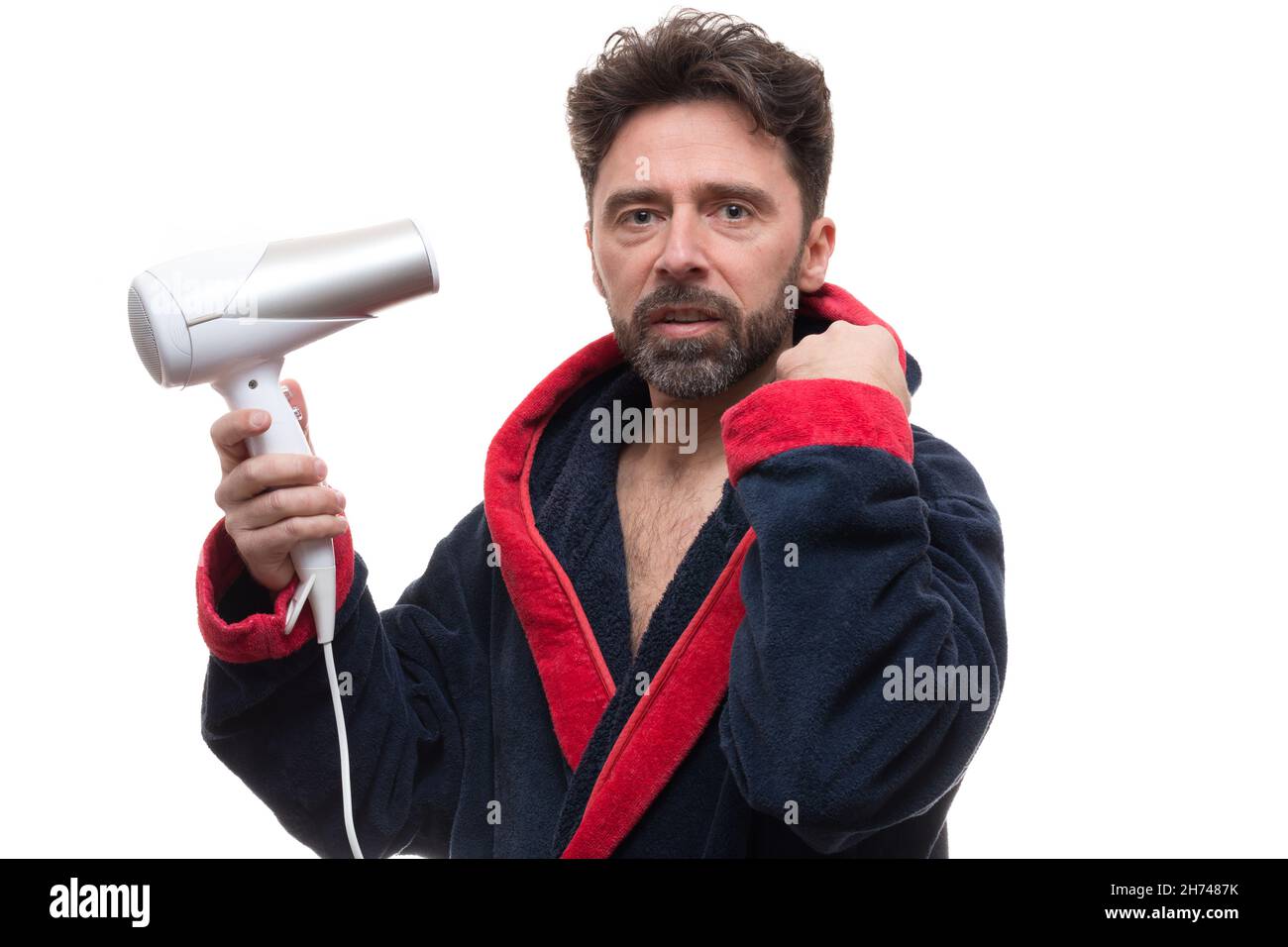 Adult male in a robe posing with a dryer blower on the white background