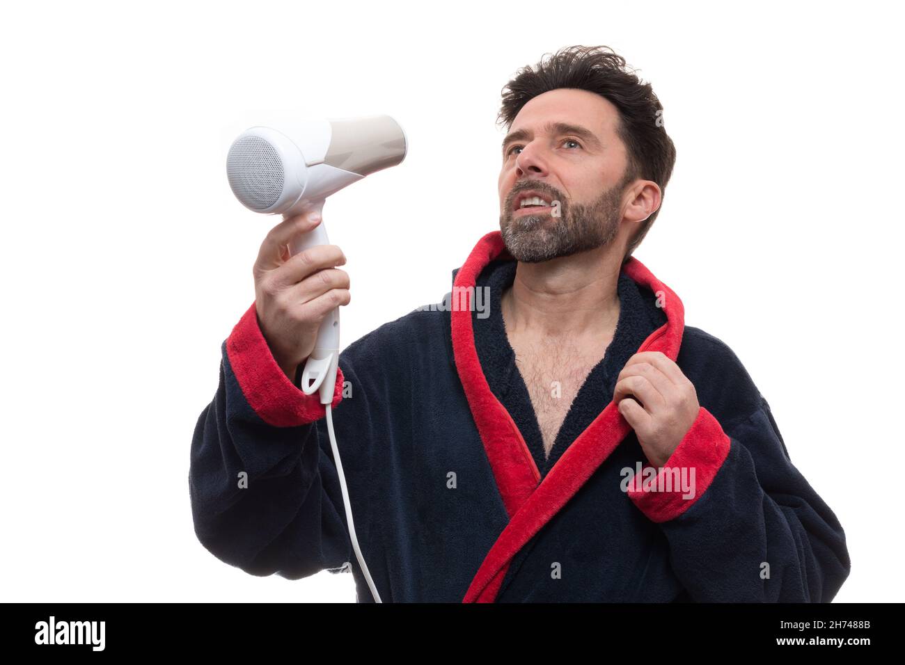 Adult male in a robe posing with a dryer blower on the white background