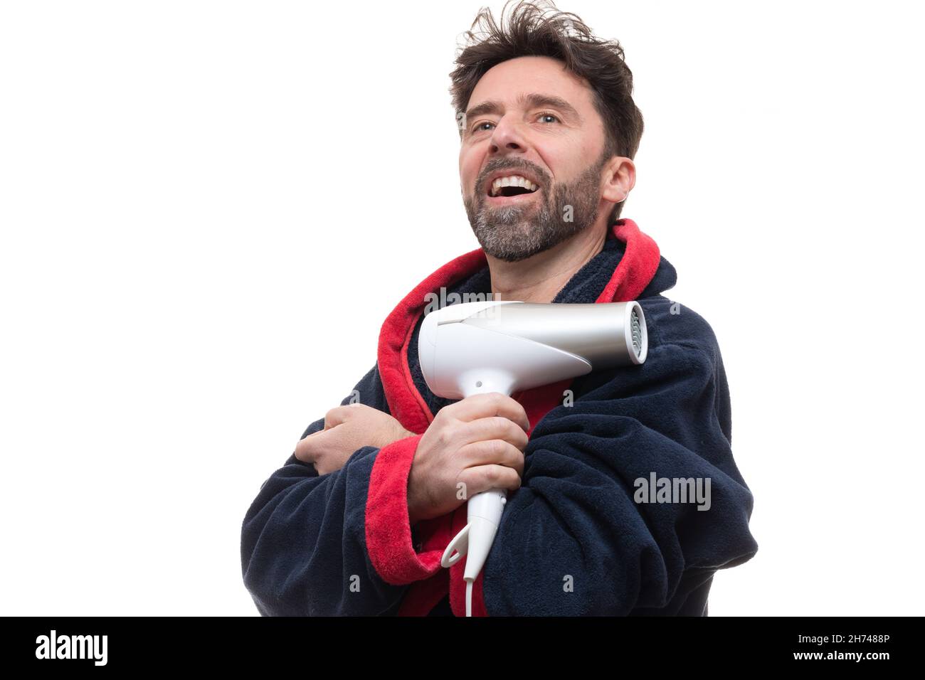 Adult male in a robe posing with a dryer blower on the white background