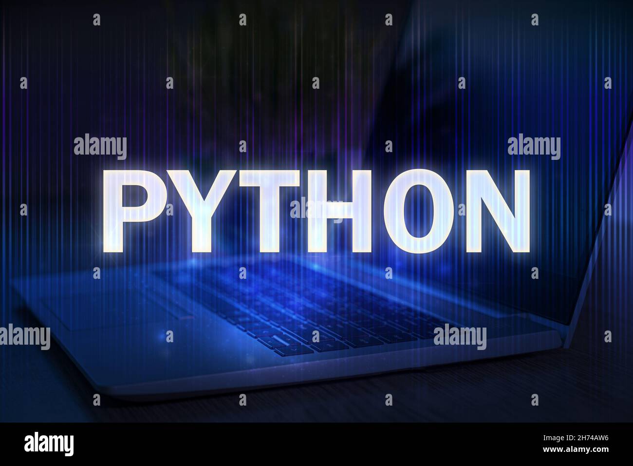 Python text on blue technology background with laptop. Learn python programming language, computer courses, training. Stock Photo