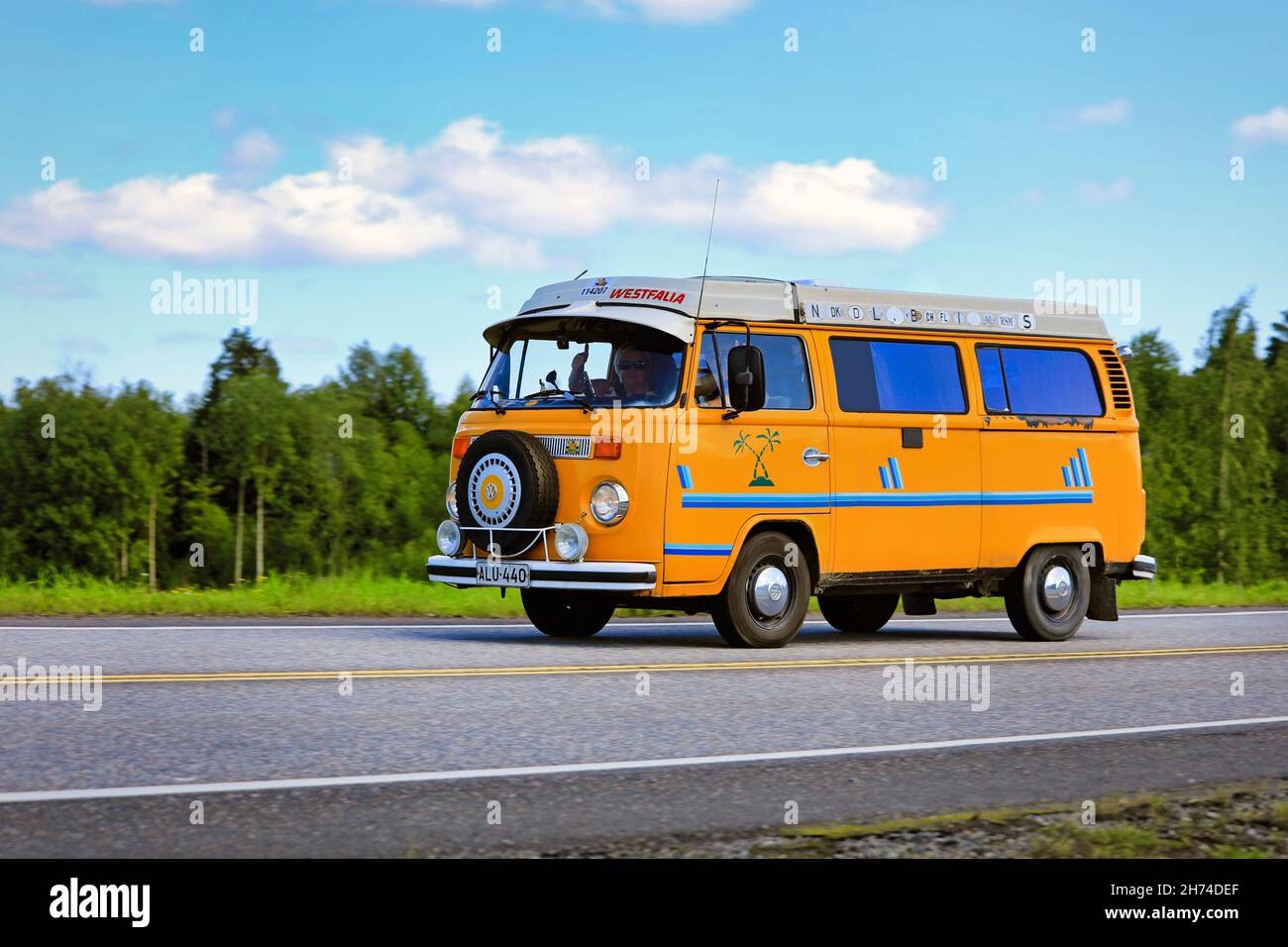 Classic yellow Volkswagen Westfalia camper van at speed on Highway 2 on a beautiful day of summer. Forssa, Finland. July 31, 2020. Stock Photo