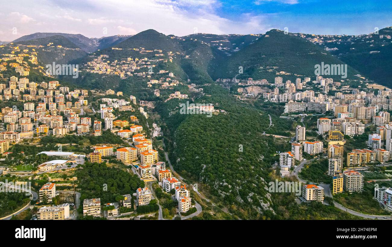 Aerial view of a city on the mountains with white buildings and scenic ...