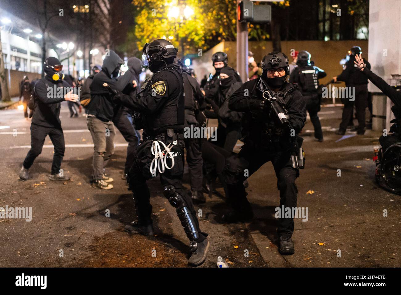 Police rush protesters at the south entrance of the Justice Center during a protest to decry the verdict in the Kyle Rittenhouse Trial. Portland, Oregon, USA, November 19th, 2021 (Mathieu Lewis-Rolland/SIPA USA) Stock Photo