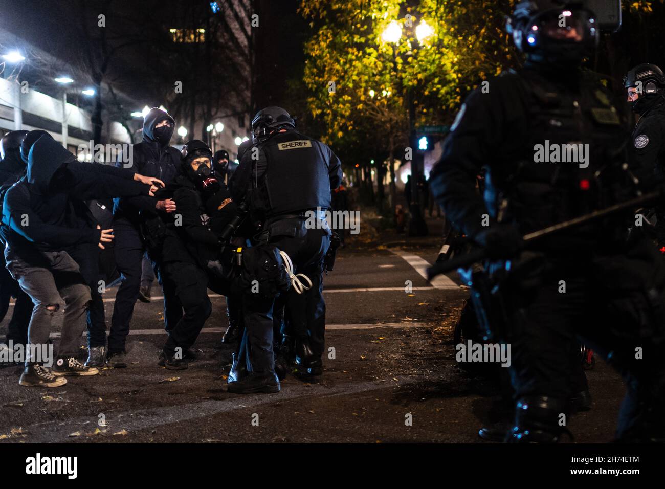 Police rush protesters at the south entrance of the Justice Center during a protest to decry the verdict in the Kyle Rittenhouse Trial. Portland, Oregon, USA, November 19th, 2021 (Mathieu Lewis-Rolland/SIPA USA) Stock Photo