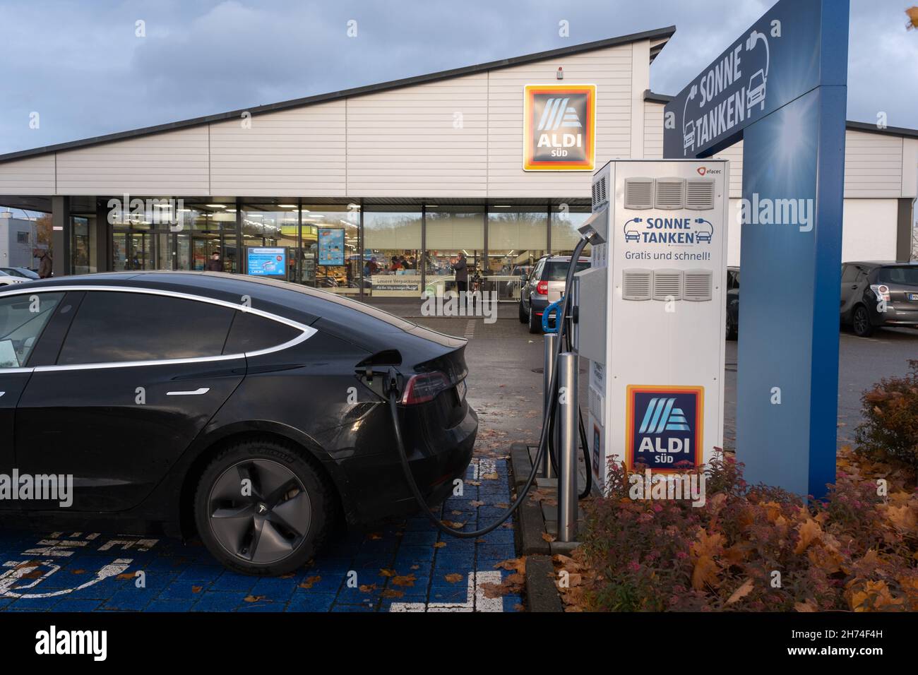 Memmingen, Germany - November 4, 2021: A static shot of a solid black Tesla Model 3 dual motor charging at LIDL supermarket DC charging station in Stock Photo - Alamy