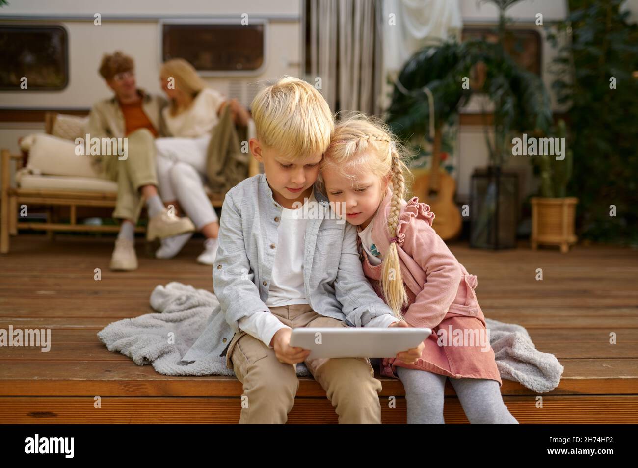 Funny children using laptop at trailer, camping Stock Photo - Alamy