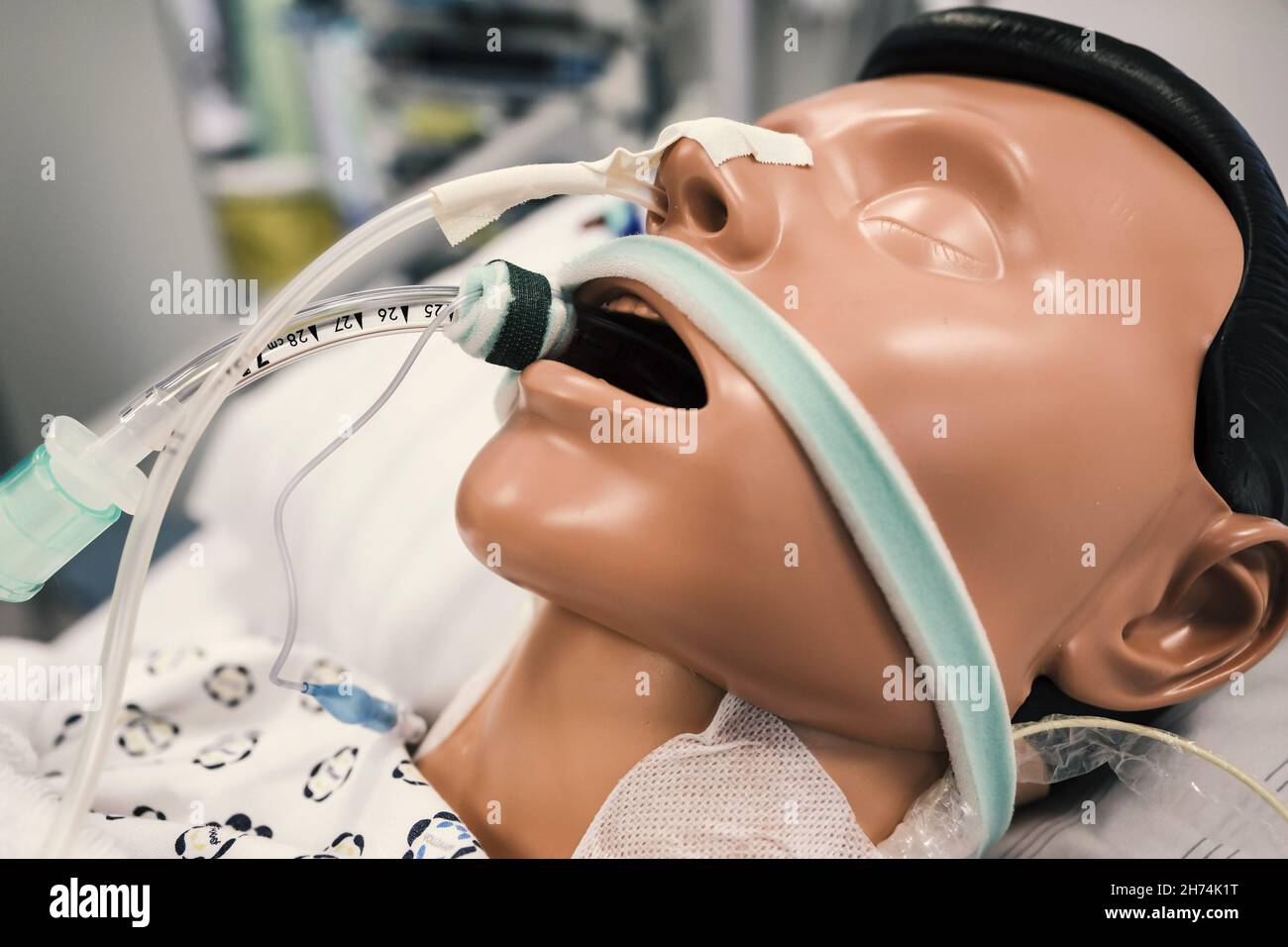 Patient dummy with intubation in hospital bed in intensive care unit of
