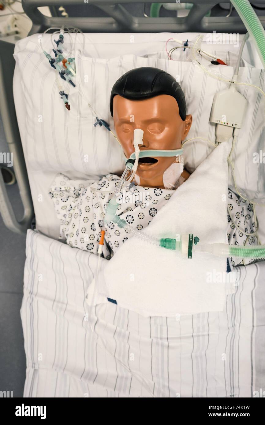 Patient dummy with intubation in hospital bed in intensive care unit of