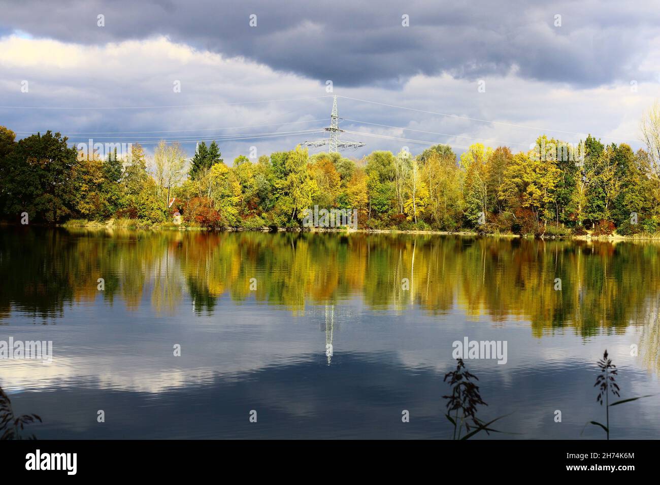 Lake reflecting the trees in fall colors in the background Stock Photo ...