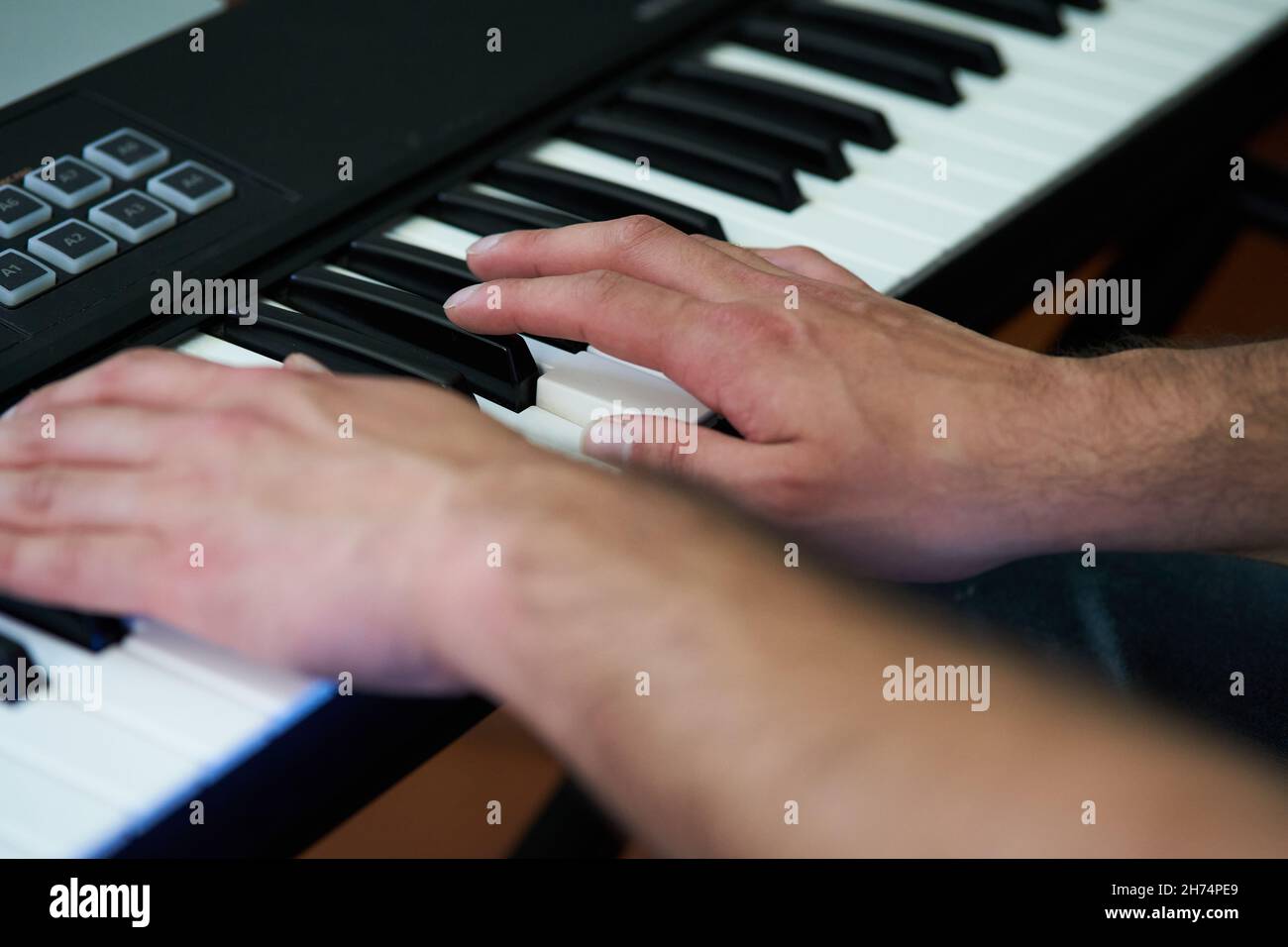 detail shot of the pianist's fingers. Home studio music Stock Photo