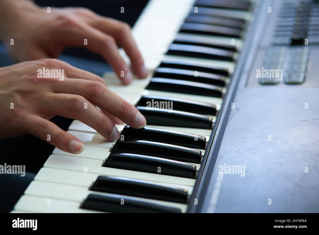 close-up detail of the pianist's fingers while playing his piano softly Stock Photo