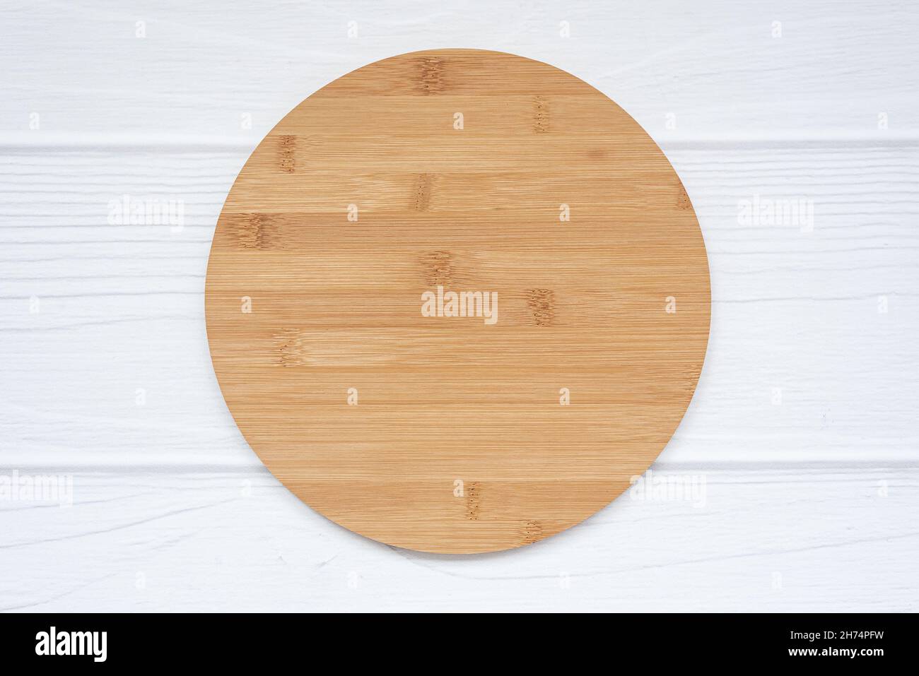 Blank round wood sign with space for text lies on white background. Stock Photo