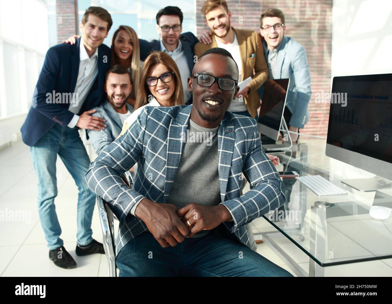 successful businessman sitting in front of business team Stock Photo ...