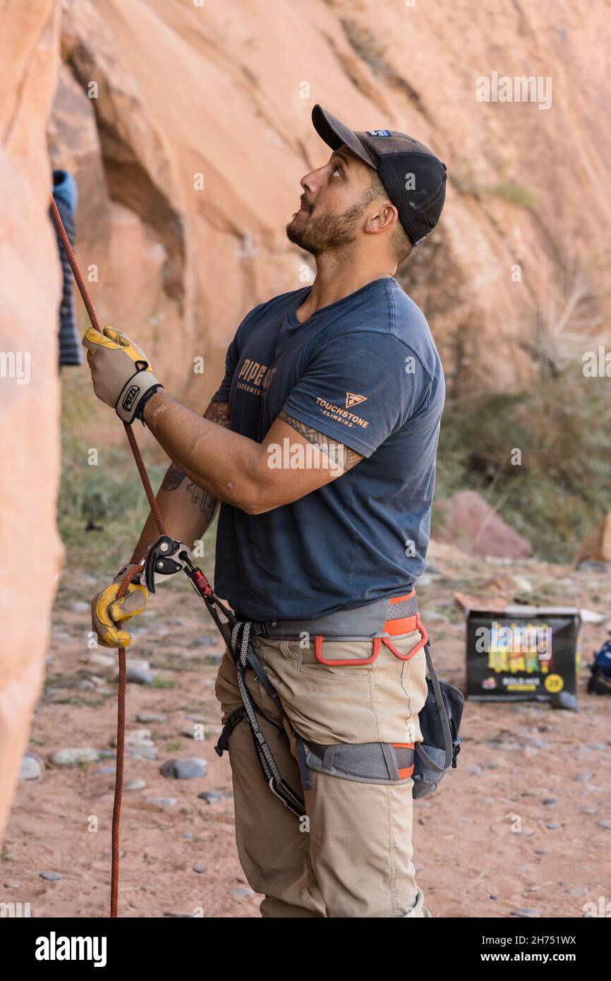 A climber belaying another climber scaling a rock wall in the Wall