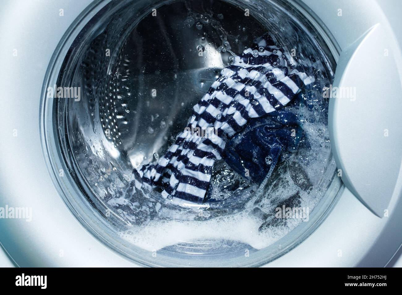 Linen washing in the washing machine. Stock Photo