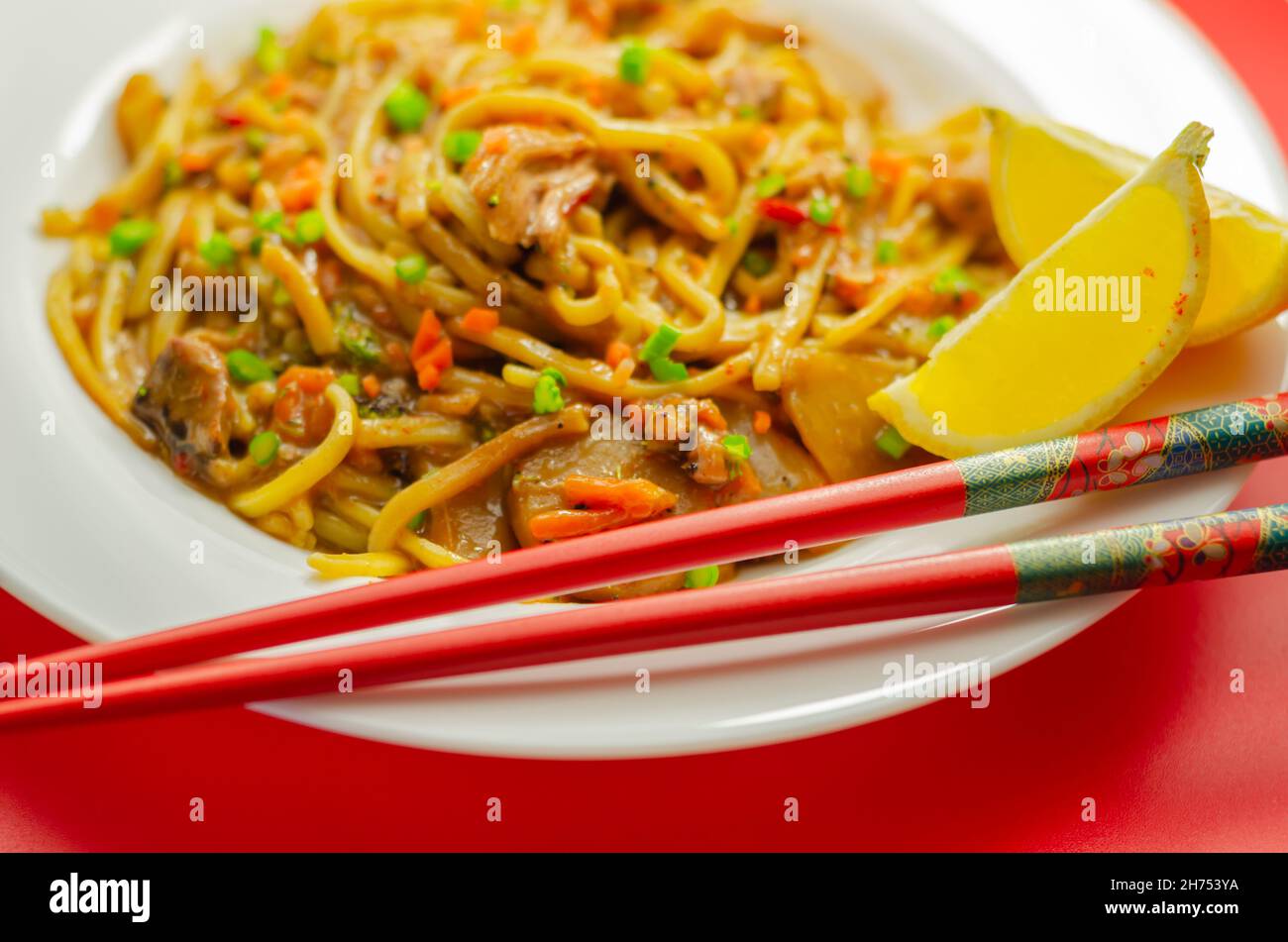 Cooked free range egg noodles with shredded duck in a savoury plum