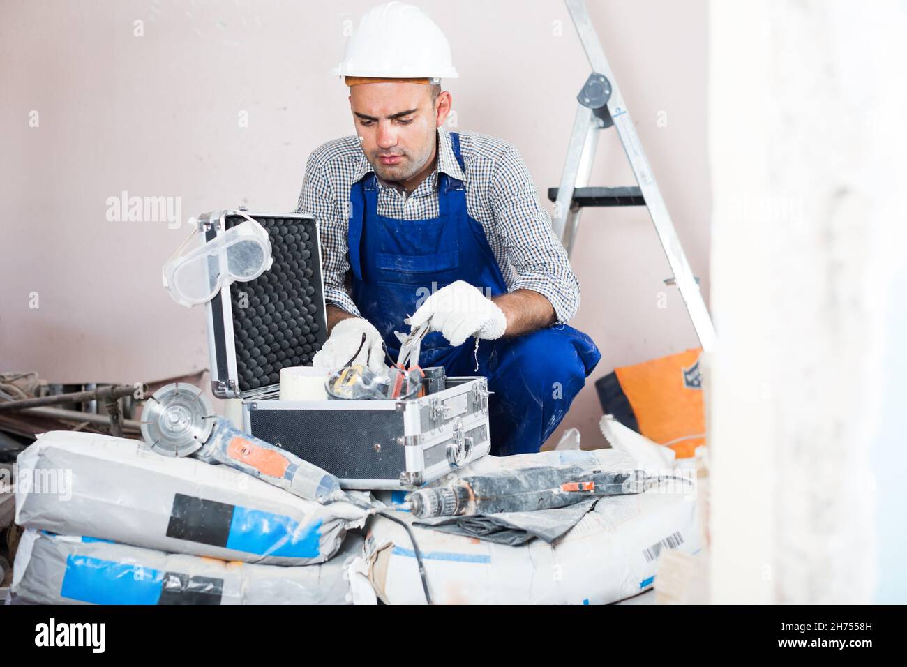 workman searching tools in toolbox Stock Photo