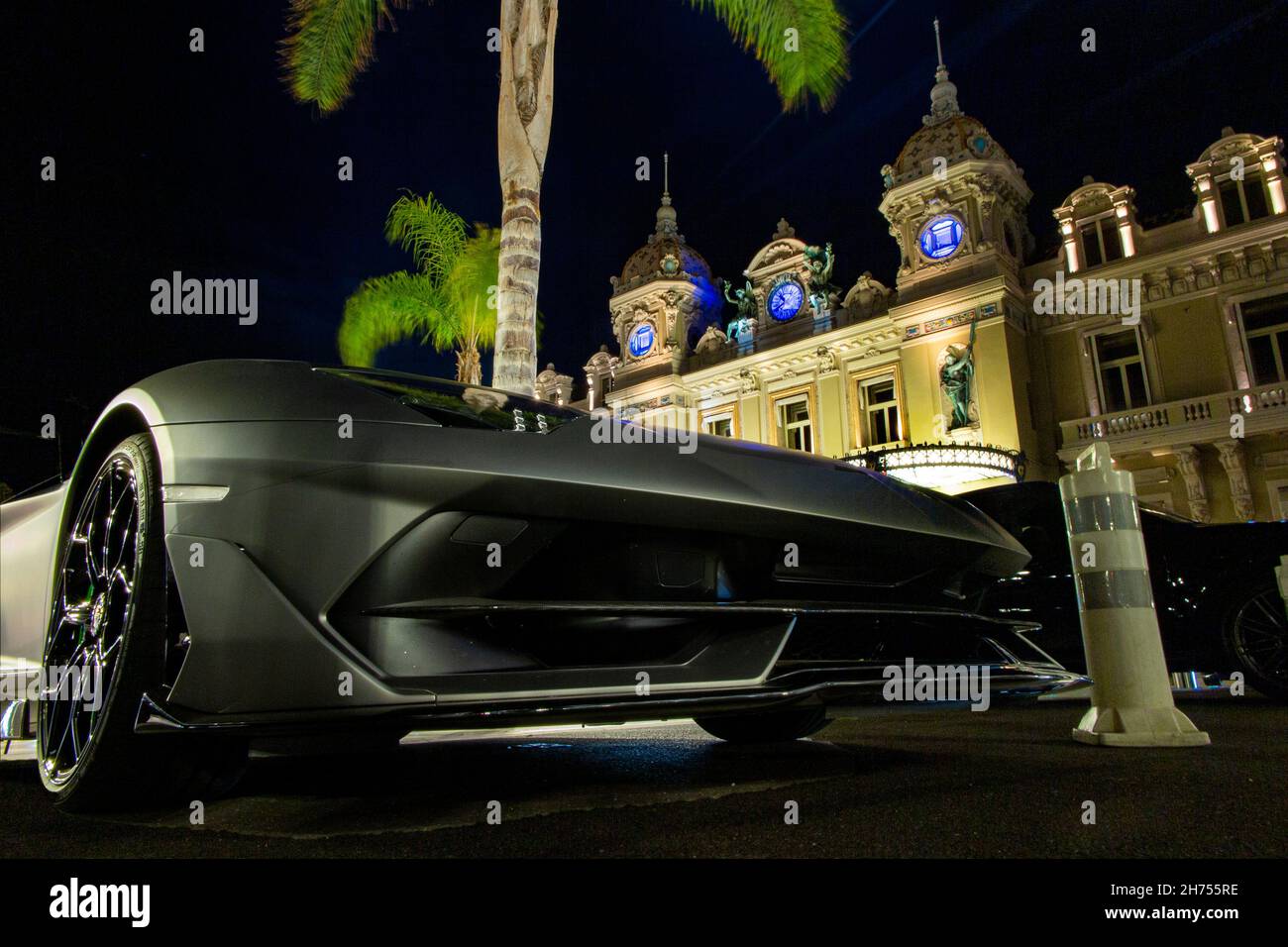 The famous Monte Carlo Casino in Monaco, France with a Lamborghini parked in front. Stock Photo
