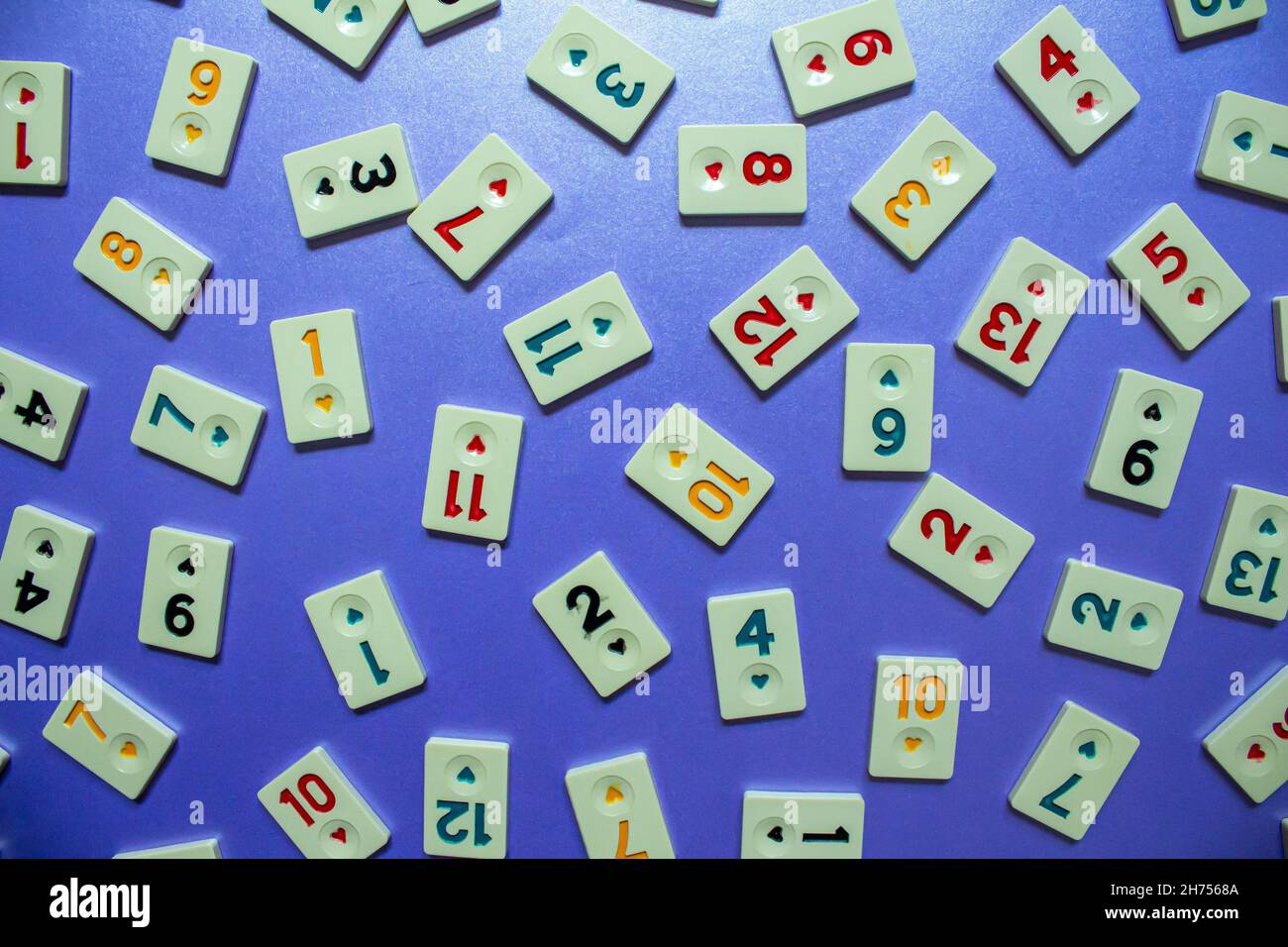Rummikub game tiles, top view of rummikub tiles isolated on navy blue