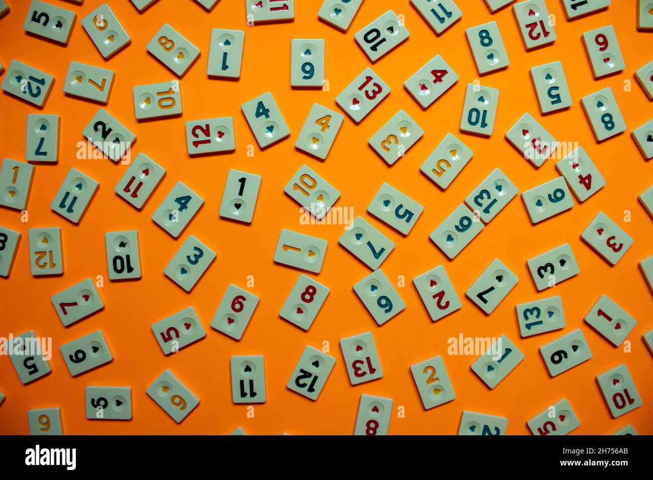 Rummikub game tiles, top view of rummikub tiles isolated on orange