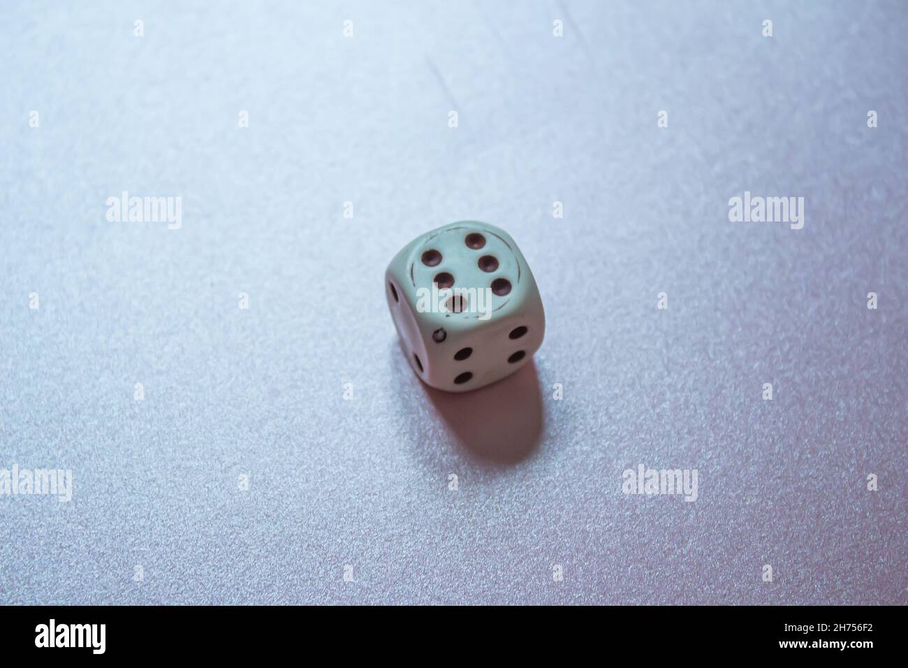 Top view dice, old white dice isolated on shiny background. Stock Photo