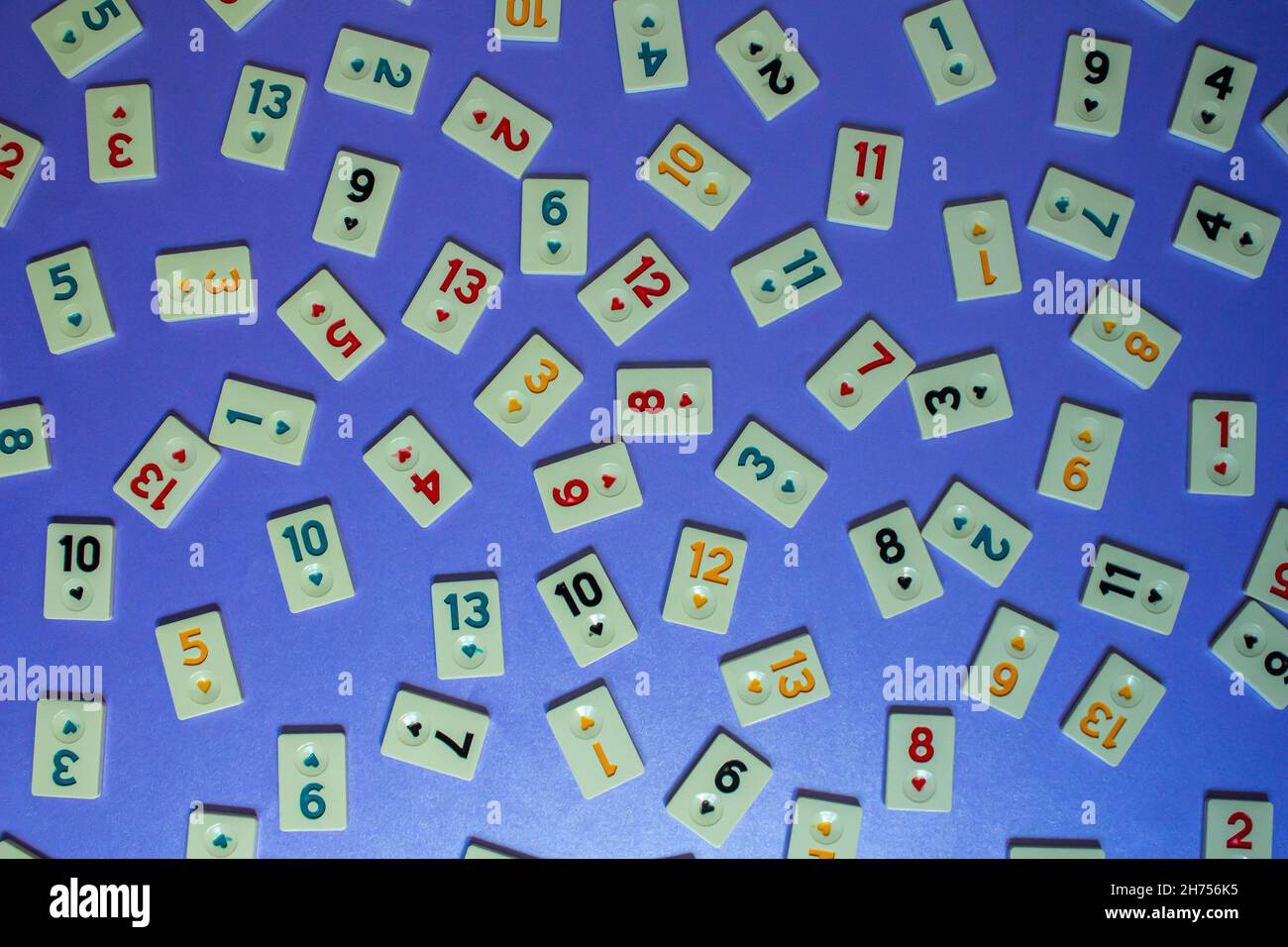 Rummikub game tiles, top view of rummikub tiles isolated on navy blue
