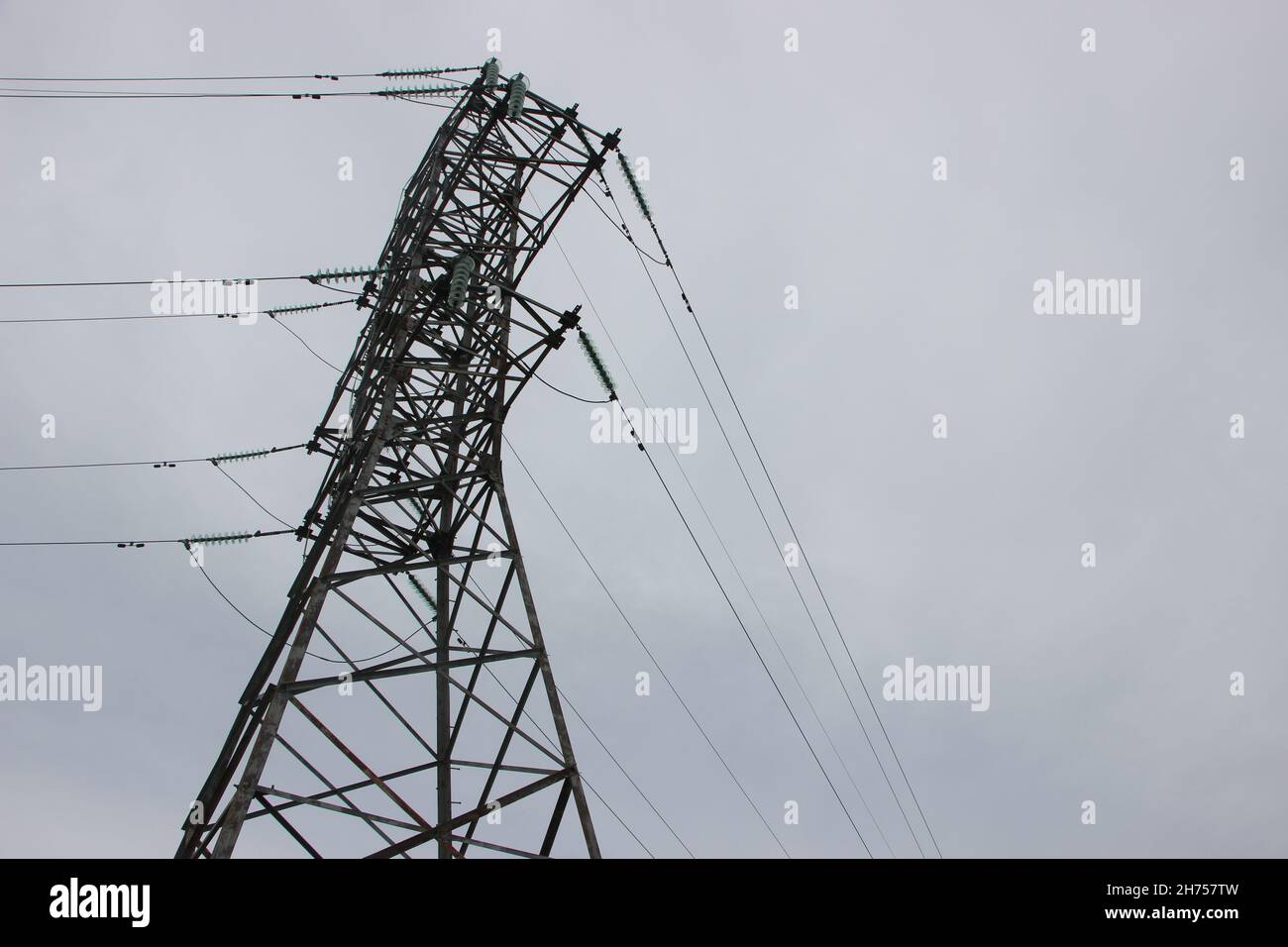 High voltage Power Transmission tower under cloudy sky. electricity concept Stock Photo