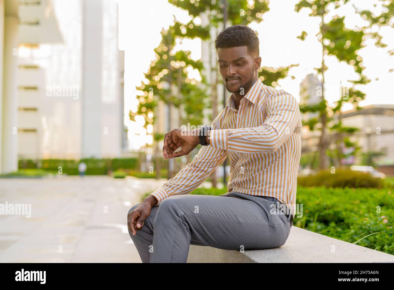 Portrait african man waiting checking hi-res stock photography and ...
