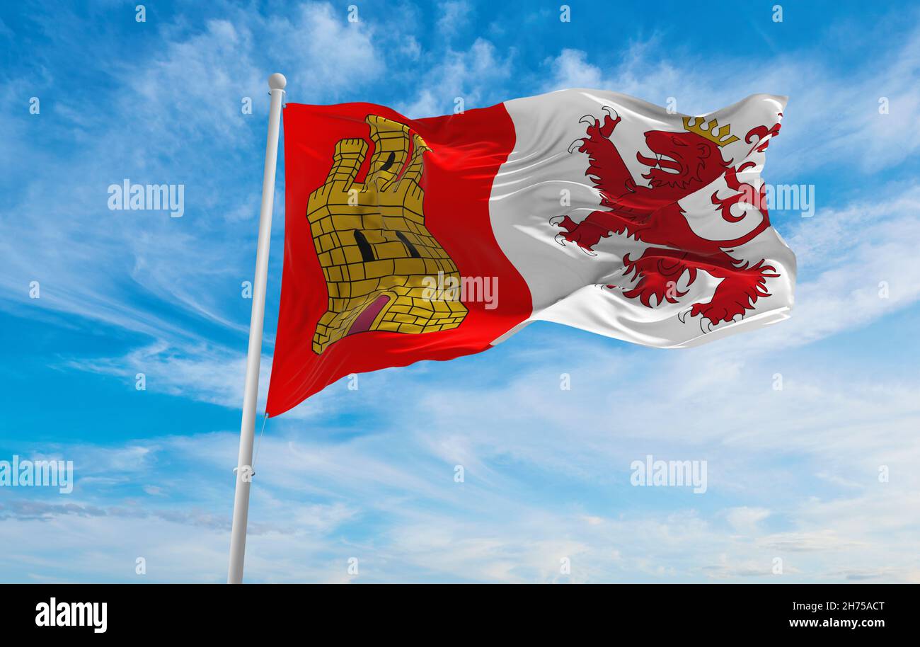 flag of Caceres , Spain at cloudy sky background on sunset, panoramic ...
